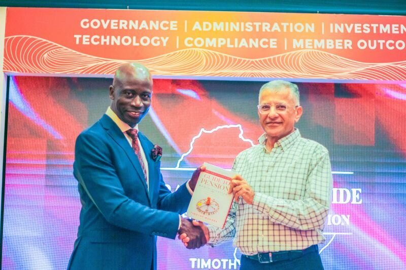 A copy of the book being presented on stage at the launch.