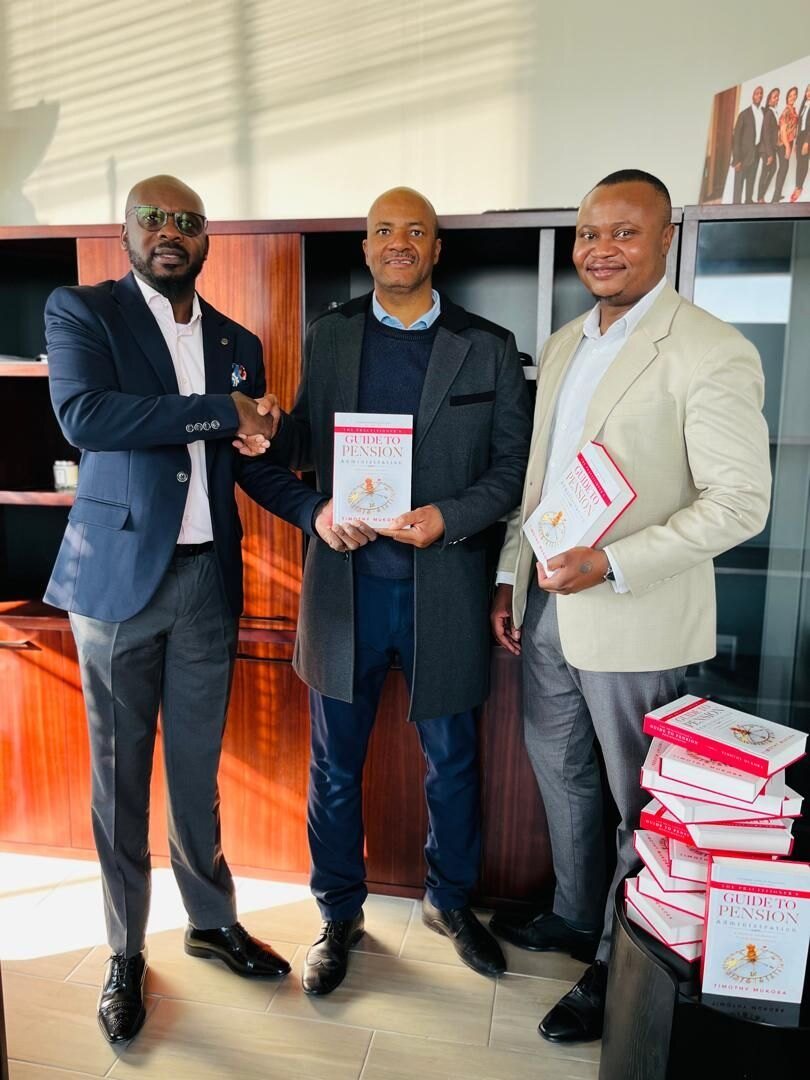 GIPF Namibia’s management receiving copies of The Practitioner’s Guide to Pension Administration.