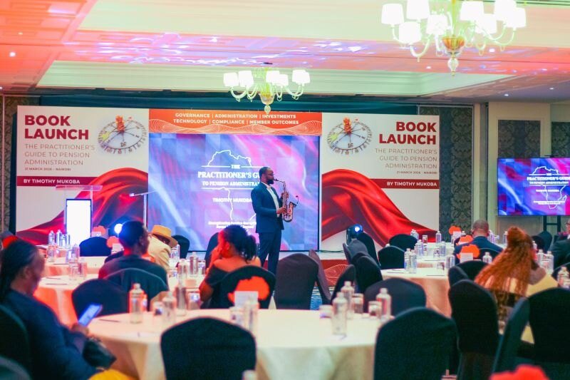 The hall at the book launch, with the launch banner behind the stage.
