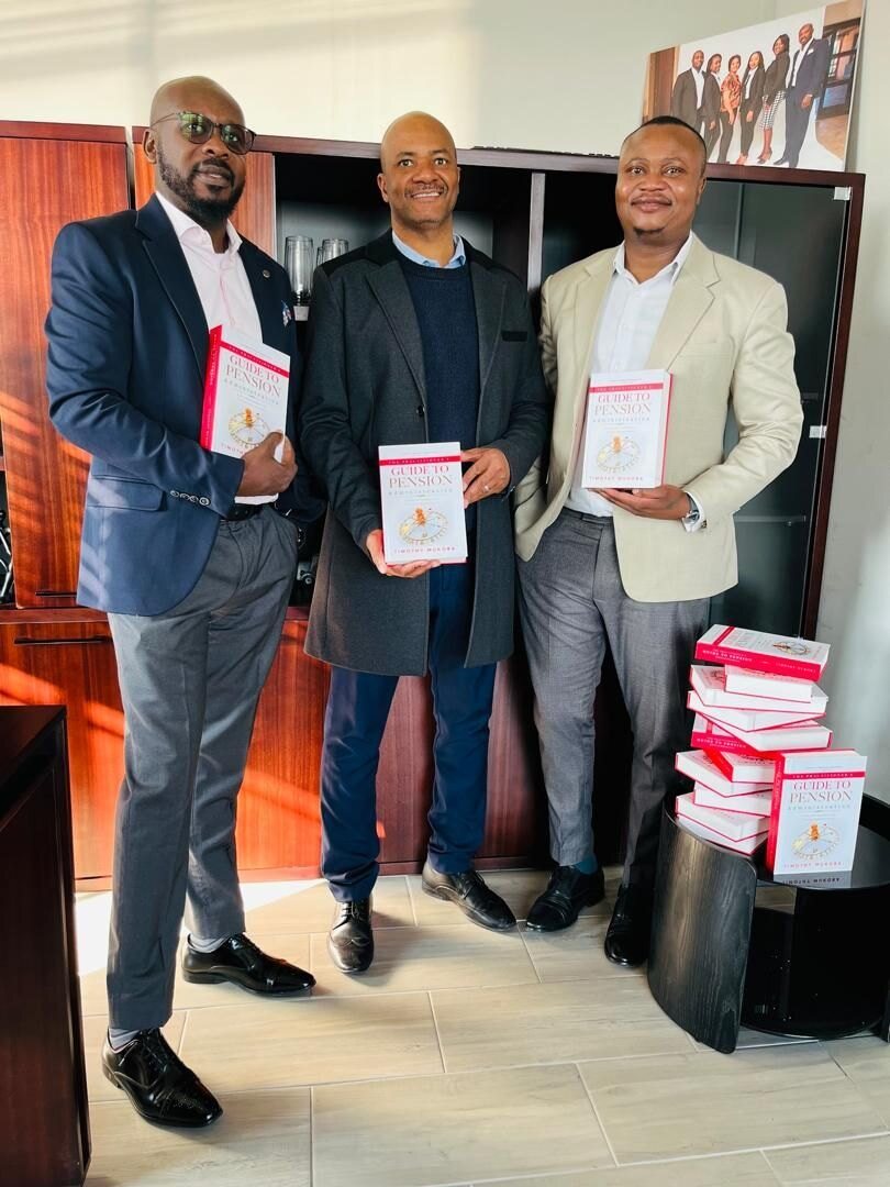 The GIPF team with copies of the book stacked beside them.
